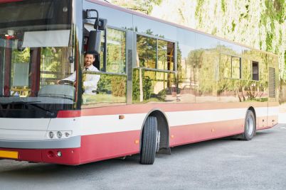 elegant-driver-sitting-shuttle-bus-smiling-camera-summer-day-front-view-happy-man_7502-10207.jpg