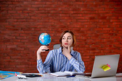 front-view-travel-agent-sitting-her-working-place-with-little-globe-assistant-map-indoors-manager-world-operator-agency-service-1-scaled.jpg