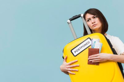 woman-holding-yellow-baggage-with-postponed-sign-with-copy-space_23-2148596908.jpg